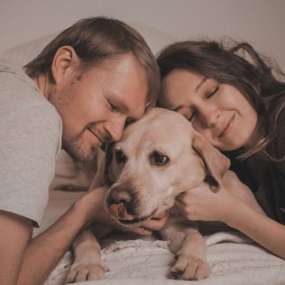 A couple at home with their Labrador.
